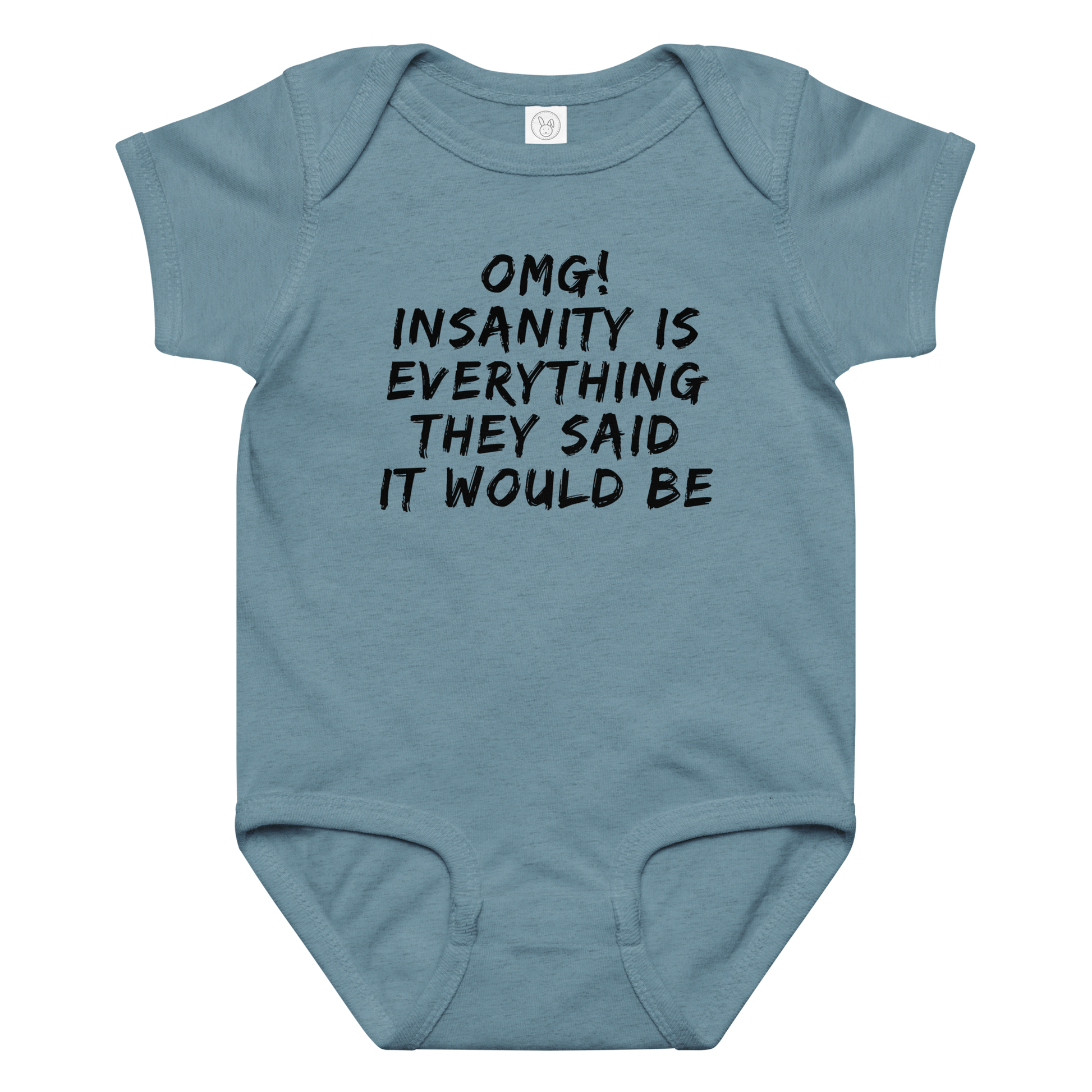 "OMG! Insanity is everything they said it would be" printed on a vintage indigo baby jersey bodysuit laying on a flat surface amongst other clothes