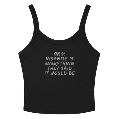 "OMG! Insanity is everything they said it would be" printed on a solid black blend women's micro-rib tanktop laying on a flat surface amongst sunglasses and shorts