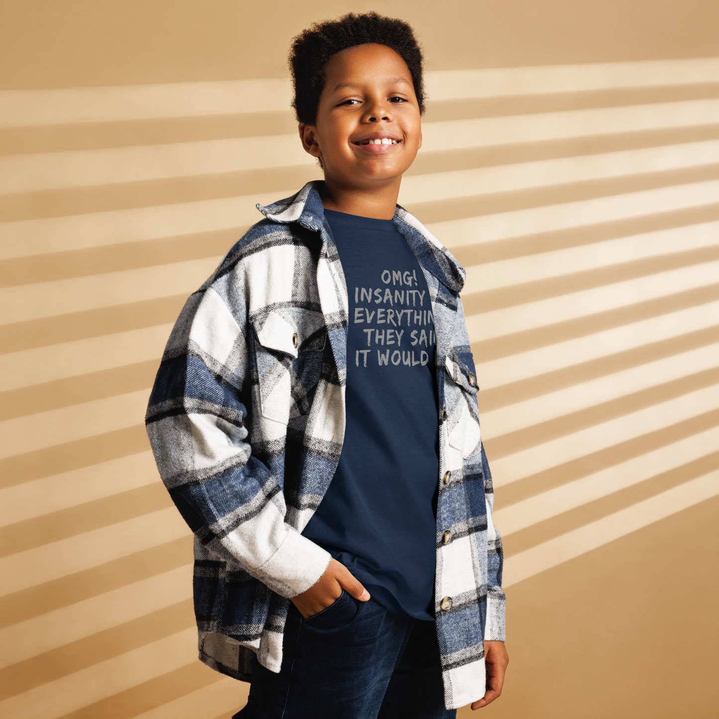 "OMG! Insanity is everything they said it would be" printed on a navy youth classic tee worn by a male also wearing a jacket