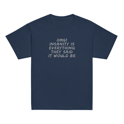 "OMG! Insanity is everything they said it would be" printed on a navy youth classic tee laying on a flat surface