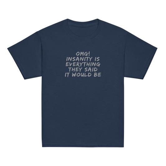 "OMG! Insanity is everything they said it would be" printed on a navy youth classic tee laying on a flat surface