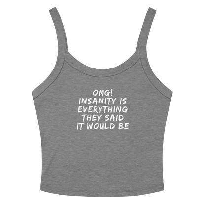 "OMG! Insanity is everything they said it would be" printed on a athletic heather women's micro-rib tanktop laying on a flat surface amongst sunglasses and shorts