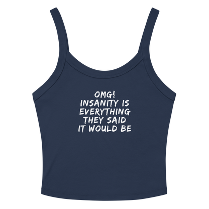 "OMG! Insanity is everything they said it would be" printed on a solid navy blend women's micro-rib tanktop laying on a flat surface amongst sunglasses and shorts