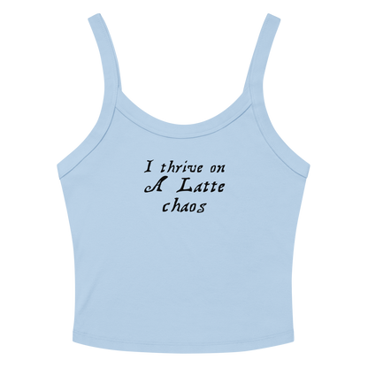"I thrive on a latte chaos" printed on a solid baby blue blend women's micro-rib tanktop laying on a flat surface amongst sunglasses and shorts
