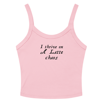 "I thrive on a latte chaos" printed on a solid pink blend women's micro-rib tanktop laying on a flat surface amongst sunglasses and shorts