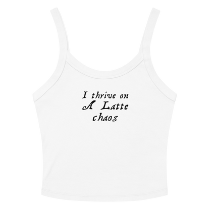 "I thrive on a latte chaos" printed on a solid white blend women's micro-rib tanktop laying on a flat surface amongst sunglasses and shorts