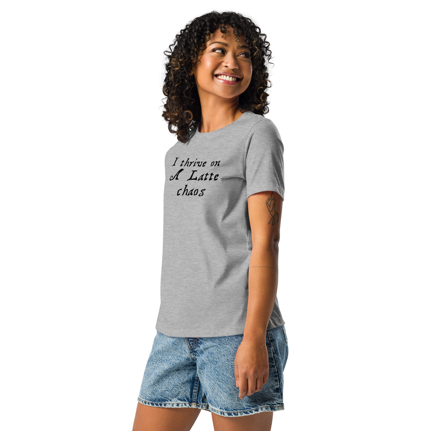 "I thrive on a latte chaos" printed on a athletic heather women's relaxed t-shirt worn by a female