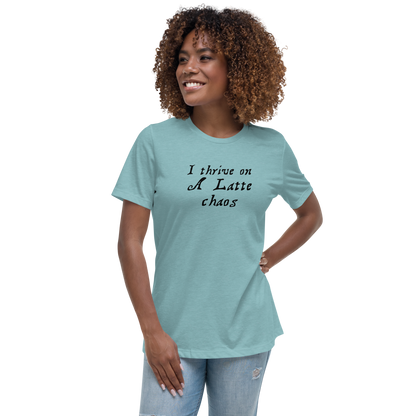 "I thrive on a latte chaos" printed on a heather blue lagoon women's relaxed t-shirt worn by a female