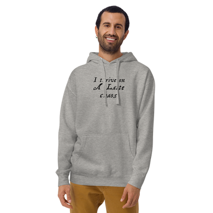 "I thrive on a latte chaos" printed on a carbon grey warn by a male