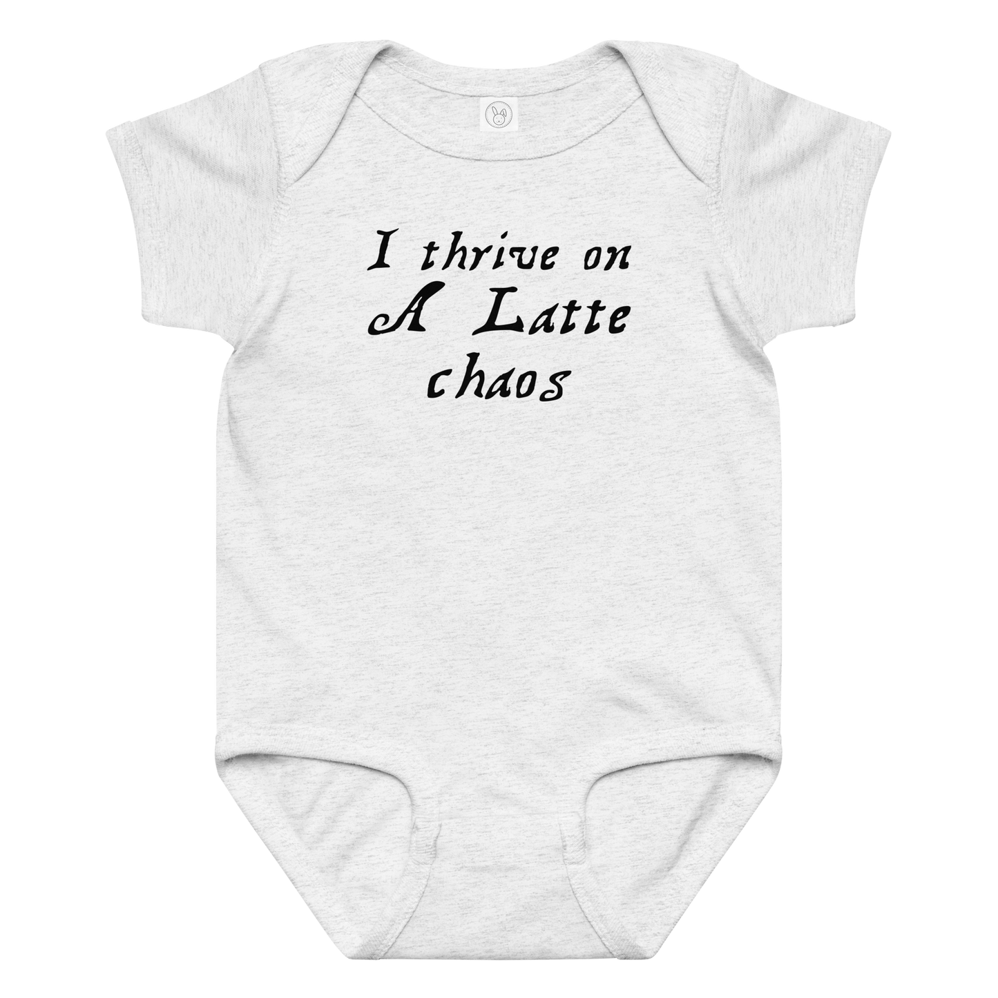 "I thrive on a latte chaos" printed on a ash baby jersey bodysuit laying on a flat surface amongst other clothes
