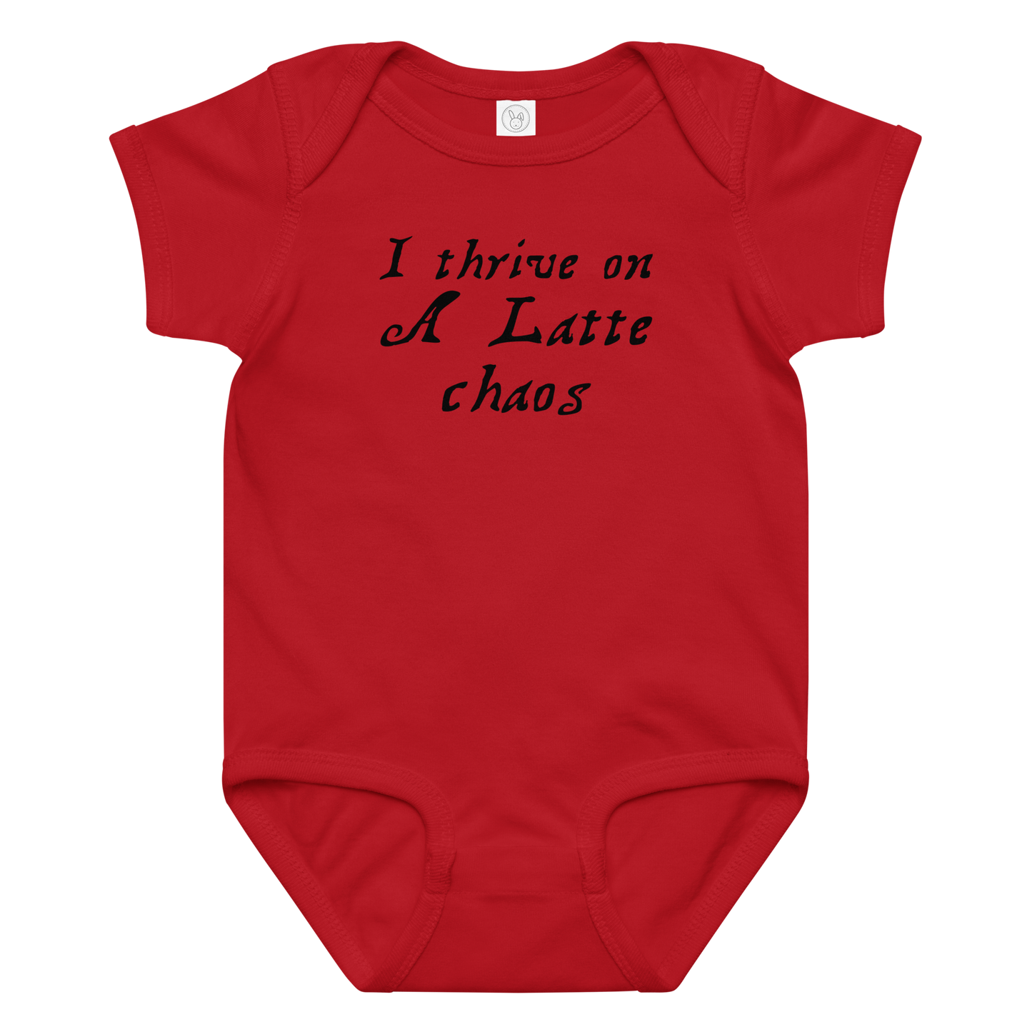 "I thrive on a latte chaos" printed on a red baby jersey bodysuit laying on a flat surface amongst other clothes