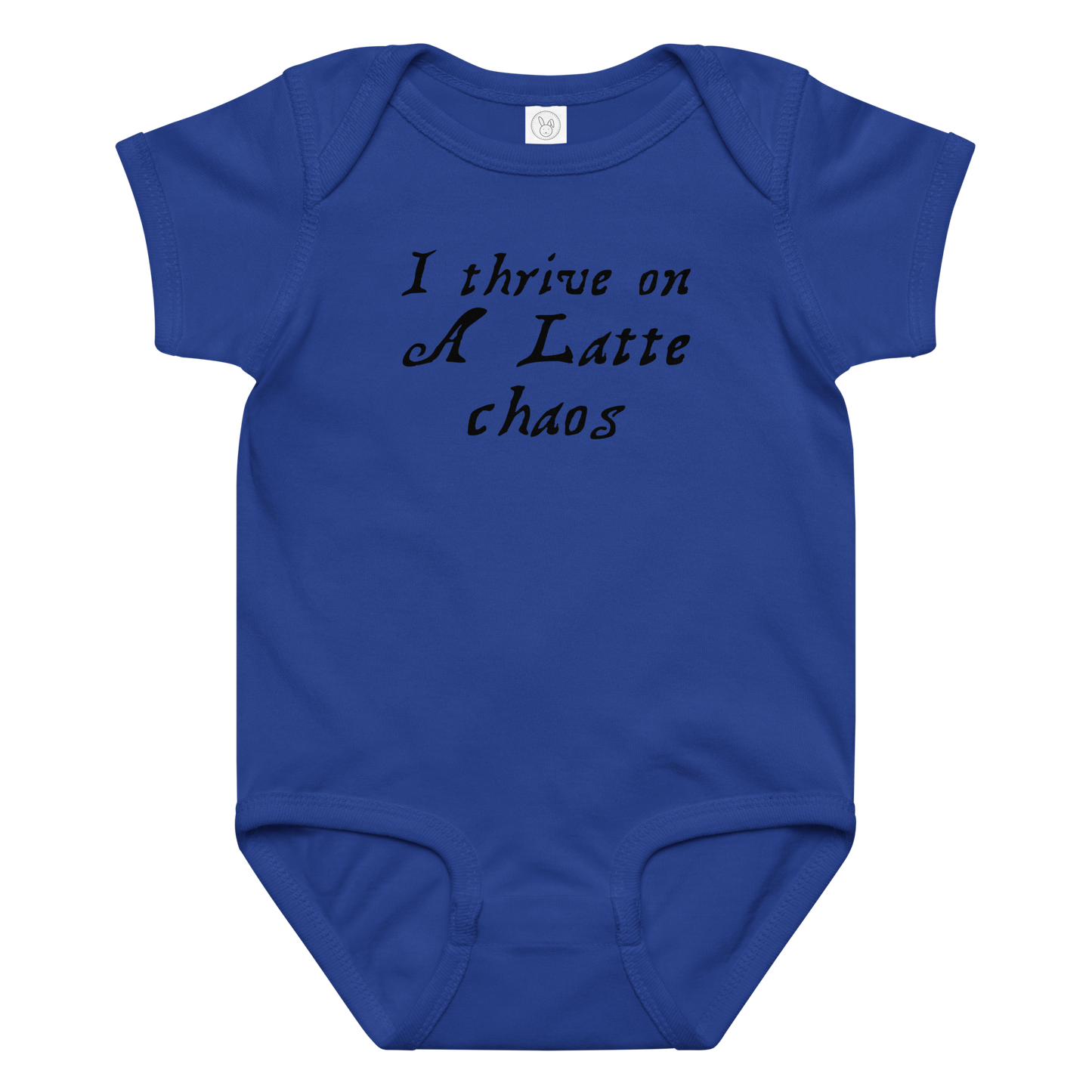 "I thrive on a latte chaos" printed on a royal baby jersey bodysuit laying on a flat surface amongst other clothes