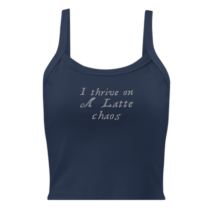 "I thrive on a latte chaos" printed on a solid navy blend women's micro-rib tanktop laying on a flat surface
