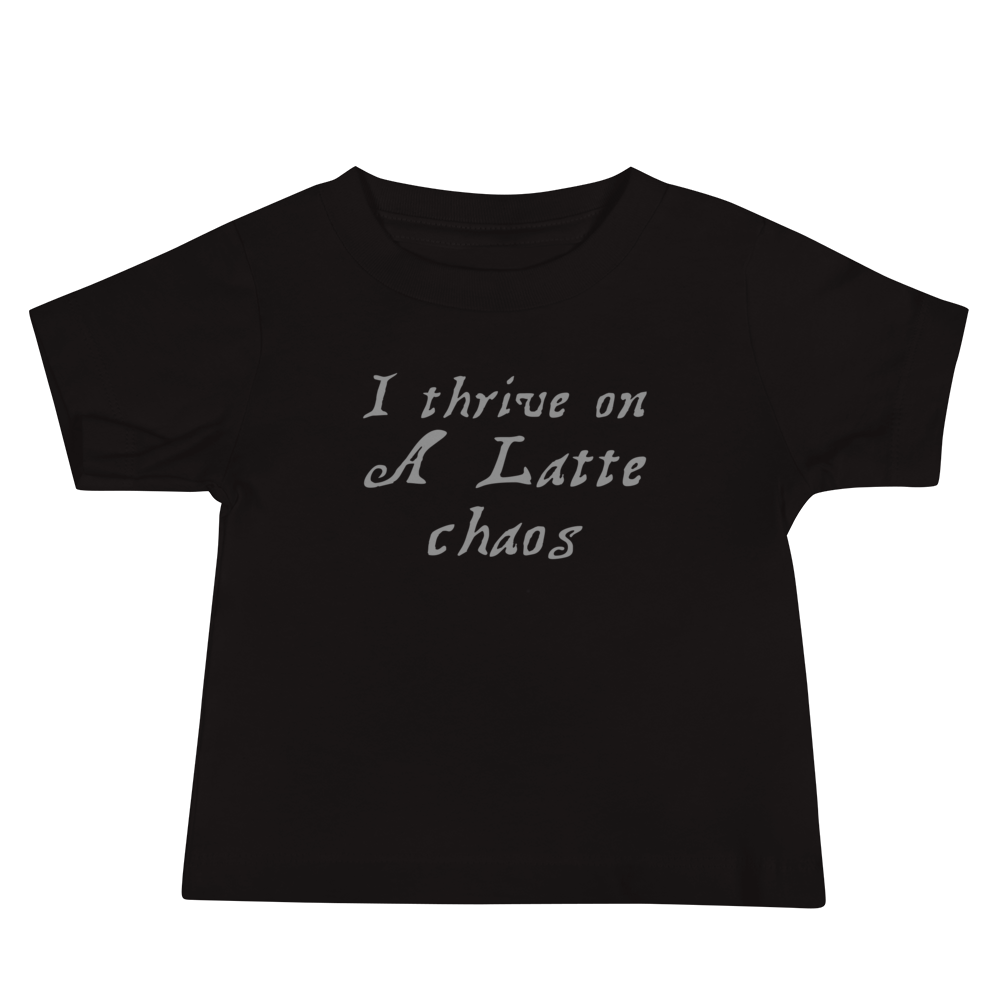 "I thrive on a latte chaos" printed on a black baby jersey short sleeve tee laying on a flat surface