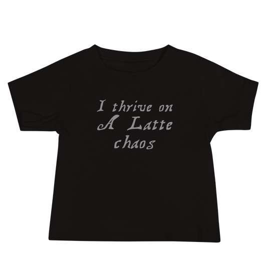 "I thrive on a latte chaos" printed on a black baby jersey short sleeve tee laying on a flat surface