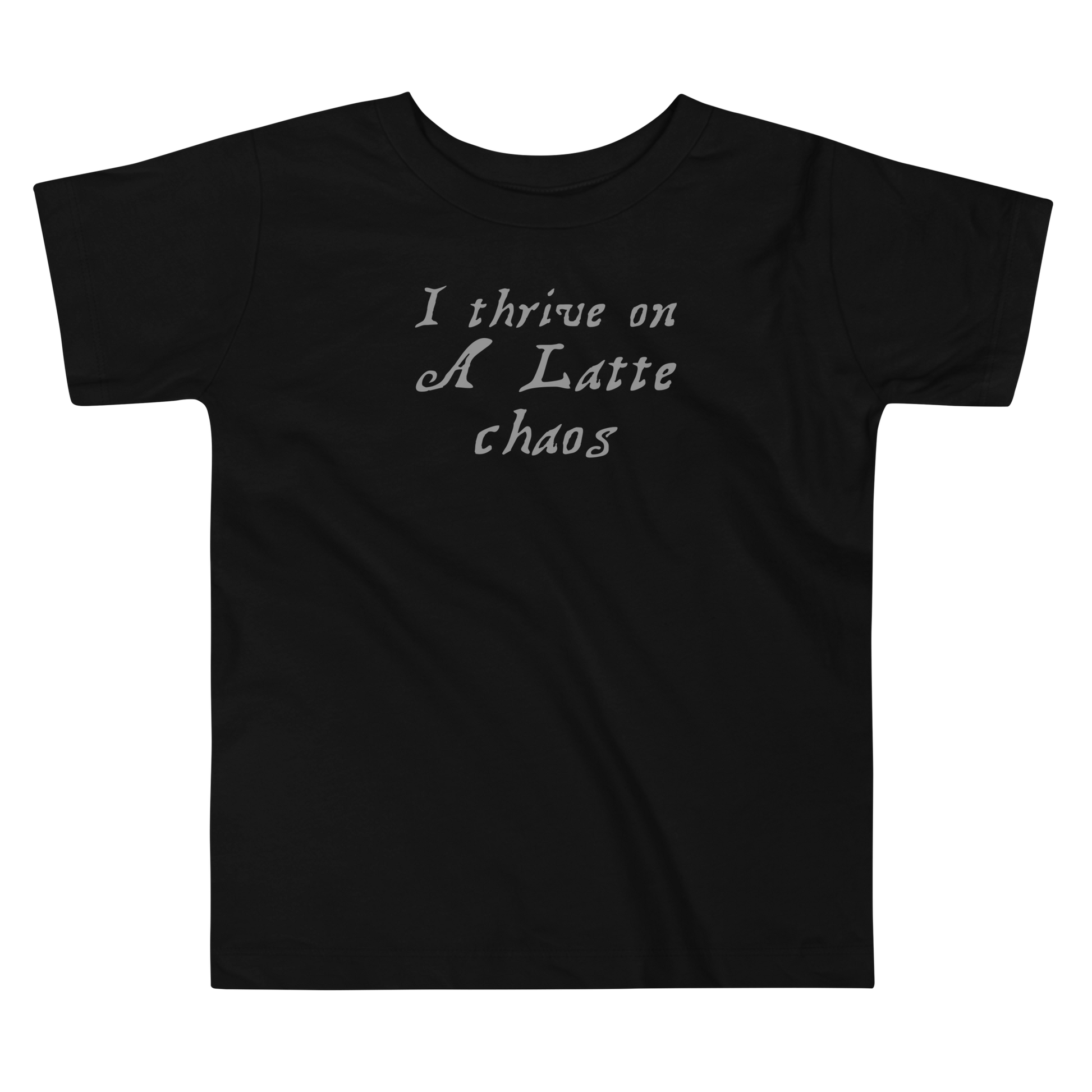 "I thrive on a latte chaos" printed on a black toddler short sleeve tee laying on a flat surface