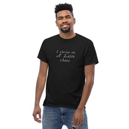 "I thrive on a latte chaos" printed on a black unisex classic tee worn by a male