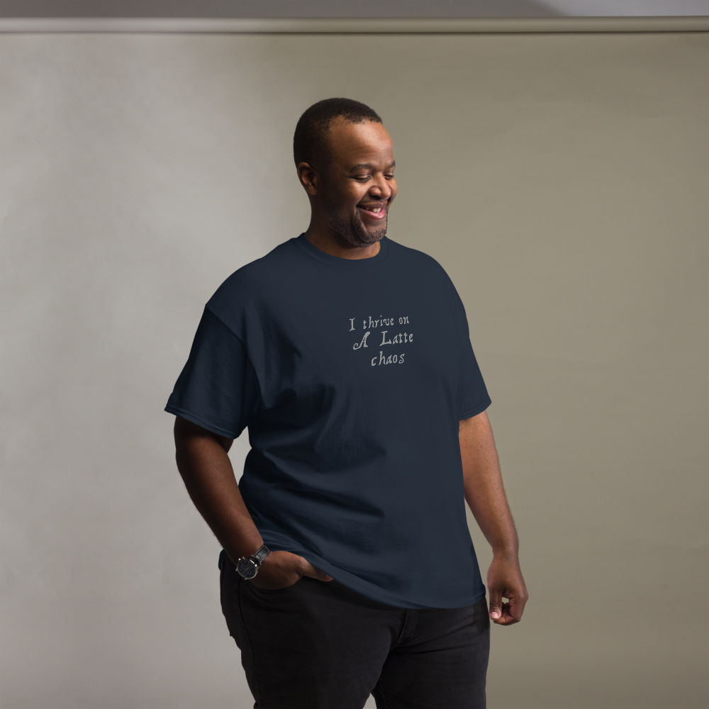 "I thrive on a latte chaos" printed on a navy unisex classic tee worn by a male