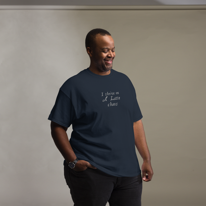 "I thrive on a latte chaos" printed on a navy unisex classic tee worn by a male