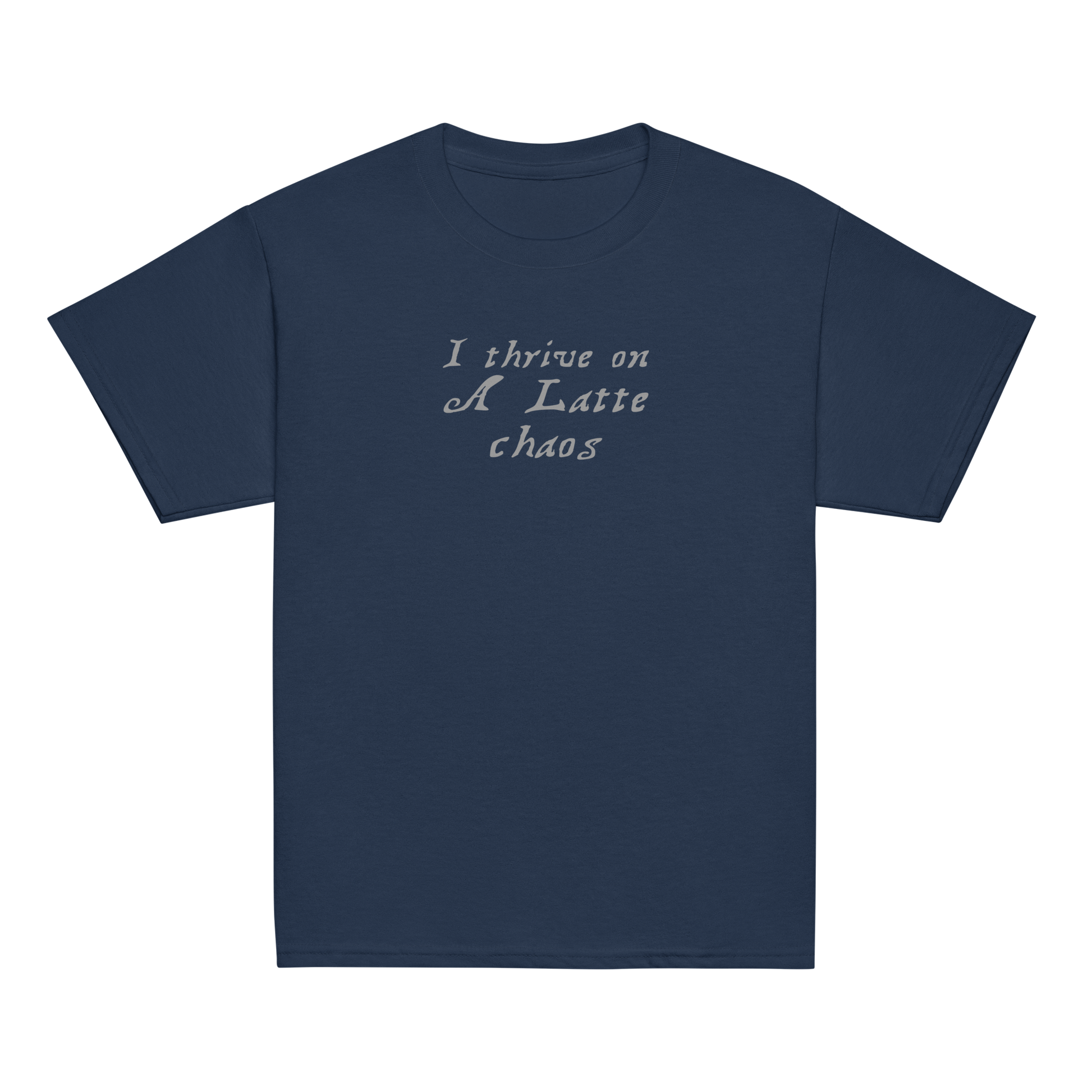 "I thrive on a latte chaos" printed on a navy youth classic tee laying on a flat surface