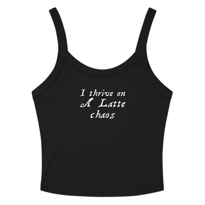"I thrive on a latte chaos" printed on a solid black blend women's micro-rib tanktop laying on a flat surface amongst sunglasses and shorts
