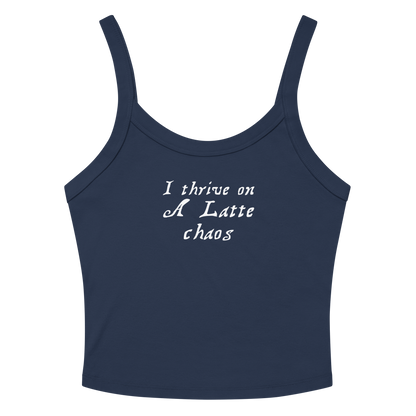 "I thrive on a latte chaos" printed on a solid navy blend women's micro-rib tanktop laying on a flat surface amongst sunglasses and shorts