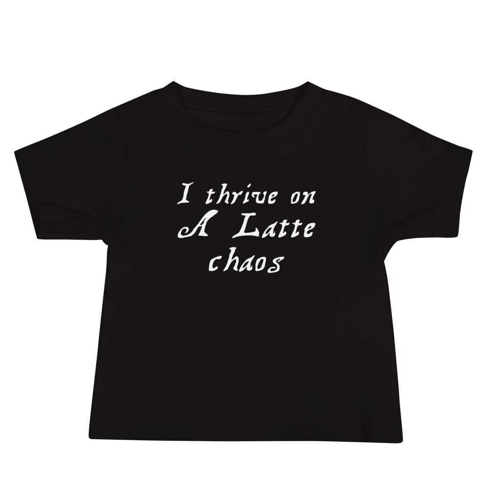 "I thrive on a latte chaos" printed on a black baby jersey short sleeve tee laying on a flat surface