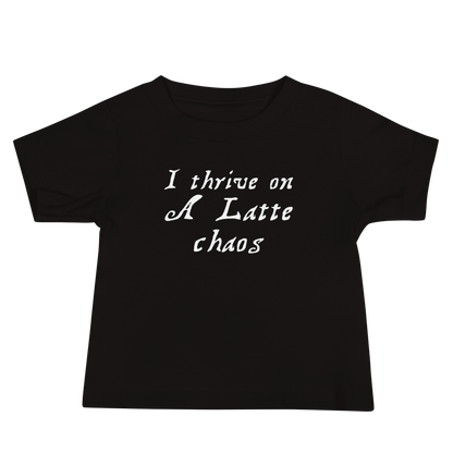 "I thrive on a latte chaos" printed on a black baby jersey short sleeve tee laying on a flat surface