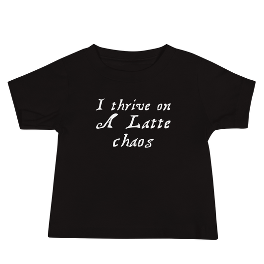 "I thrive on a latte chaos" printed on a black baby jersey short sleeve tee laying on a flat surface