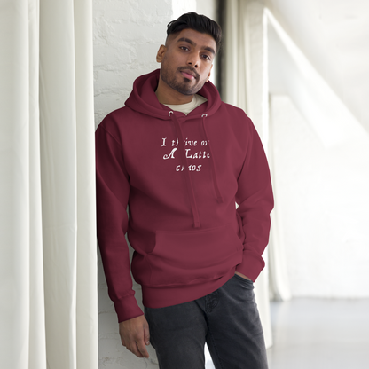 "I thrive on a latte chaos" printed on a maroon unisex hoodie worn by a male