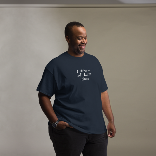 "I thrive on a latte chaos" printed on a navy unisex classic tee worn by a male