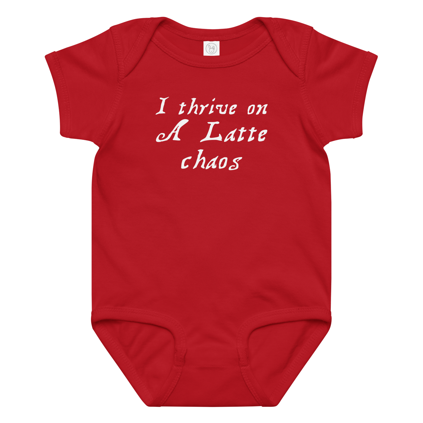 "I thrive on a latte chaos" printed on a red baby jersey bodysuit laying on a flat surface amongst other clothes