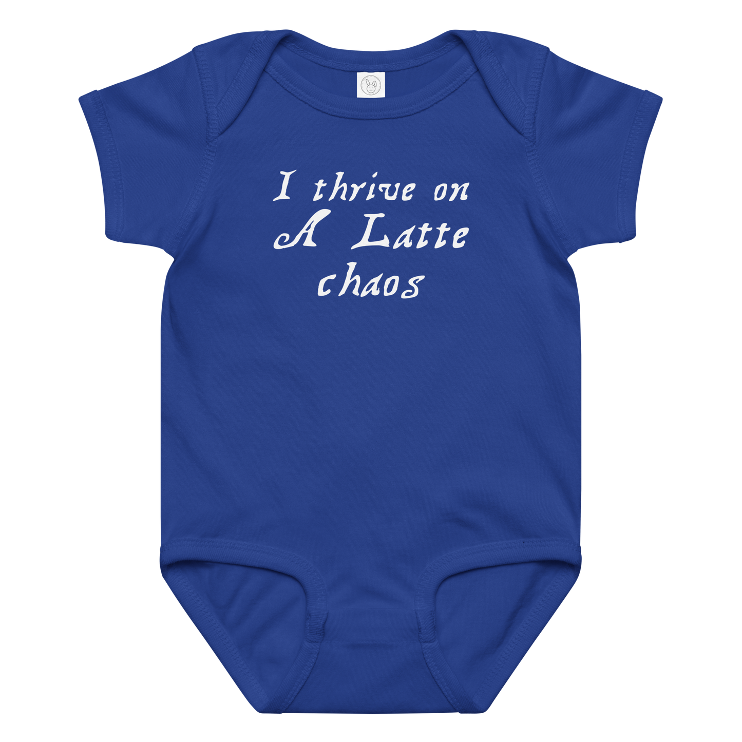 "I thrive on a latte chaos" printed on a royal baby jersey bodysuit laying on a flat surface amongst other clothes