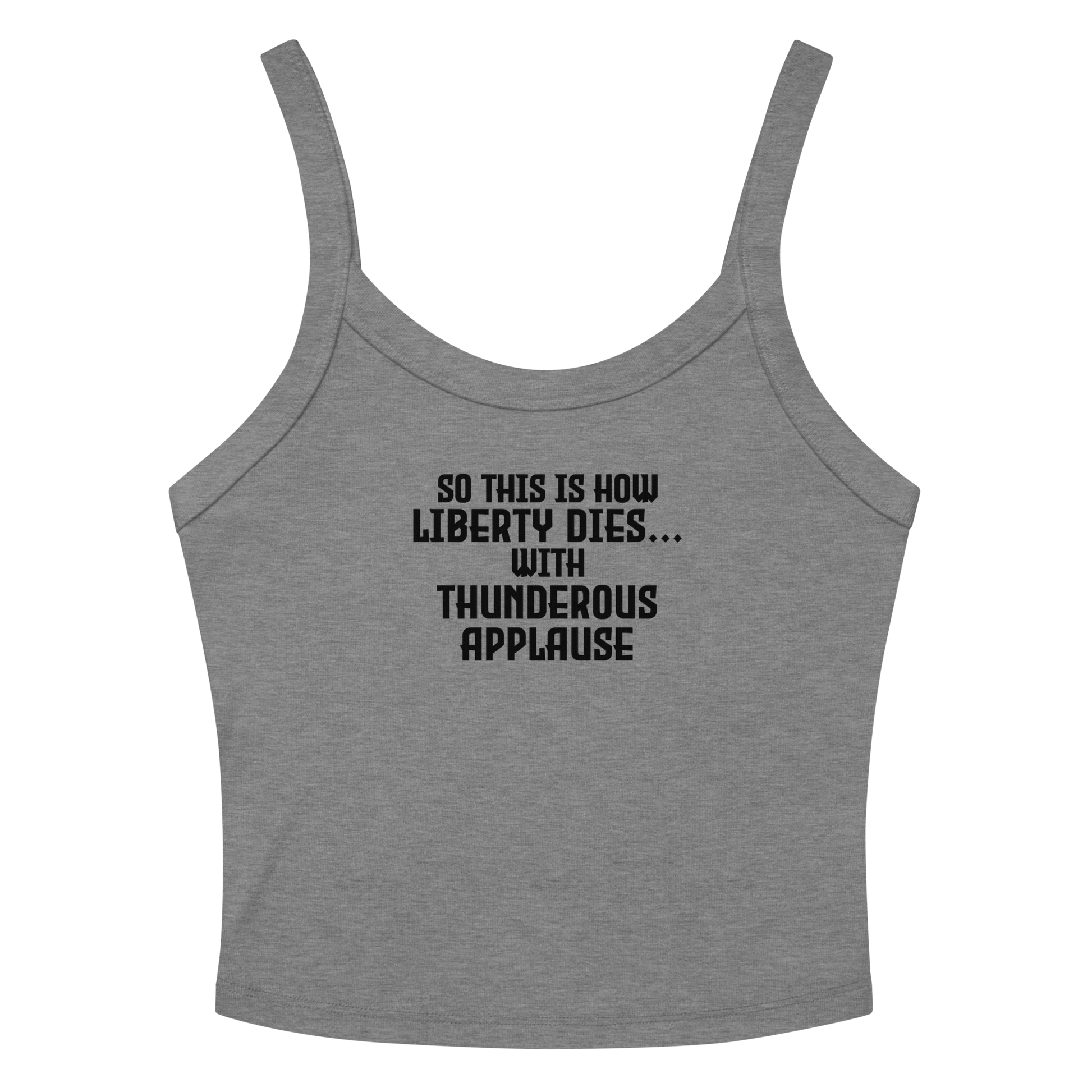 "So this is how liberty dies… with thunderous applause" printed on a athletic heather women's micro-rib tanktop laying on a flat surface amongst sunglasses and shorts