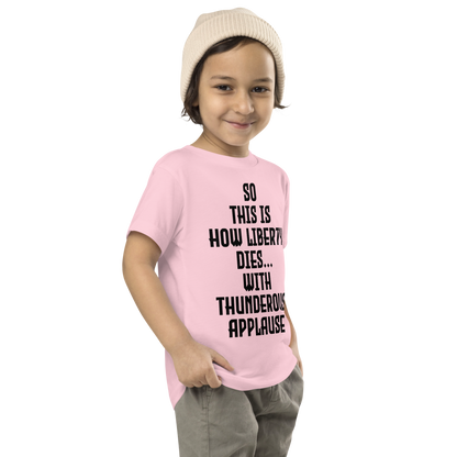 "So this is how liberty dies… with thunderous applause" printed on a pink toddler short sleeve tee worn by a male who is also wearing a knit cap