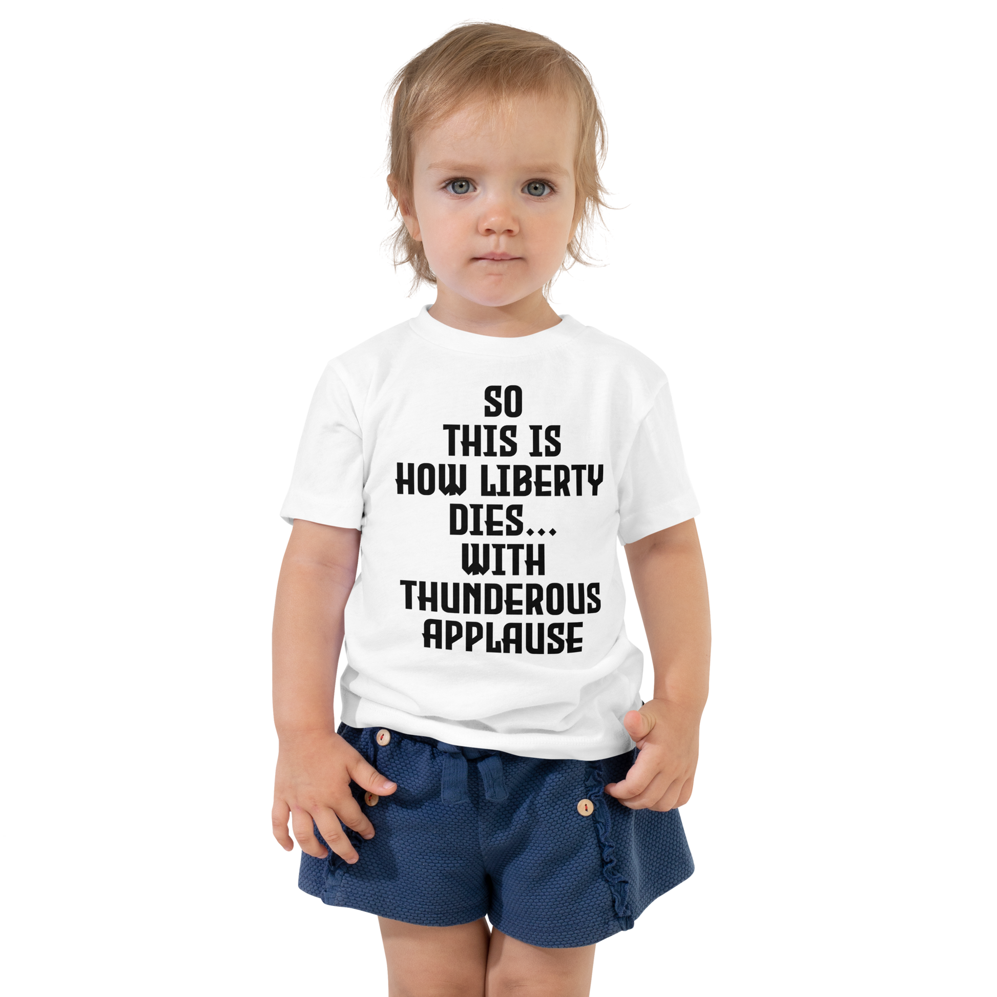 "So this is how liberty dies… with thunderous applause" printed on a white toddler short sleeve tee worn by a female