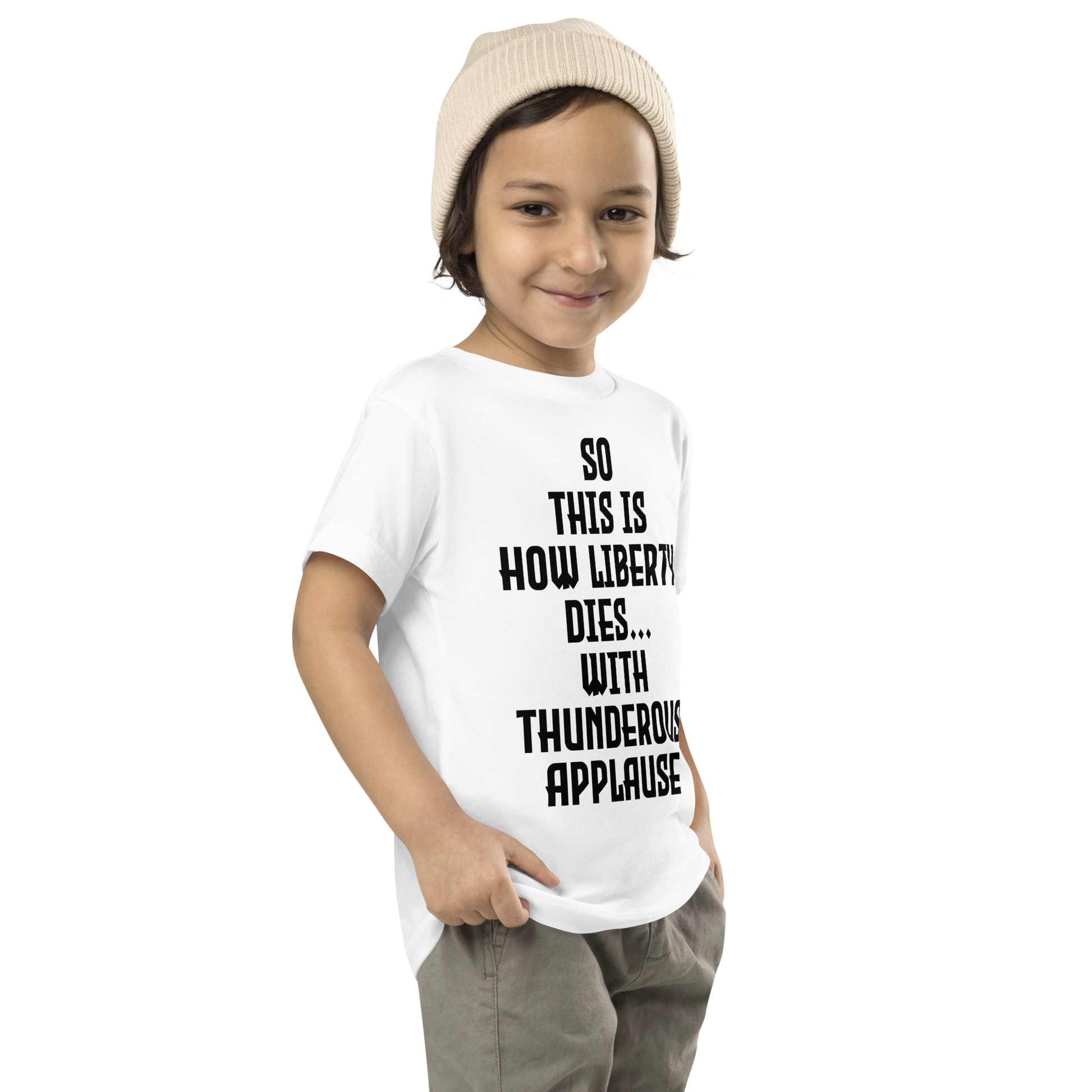"So this is how liberty dies… with thunderous applause" printed on a white toddler short sleeve tee worn by a male who is also wearing a knit cap