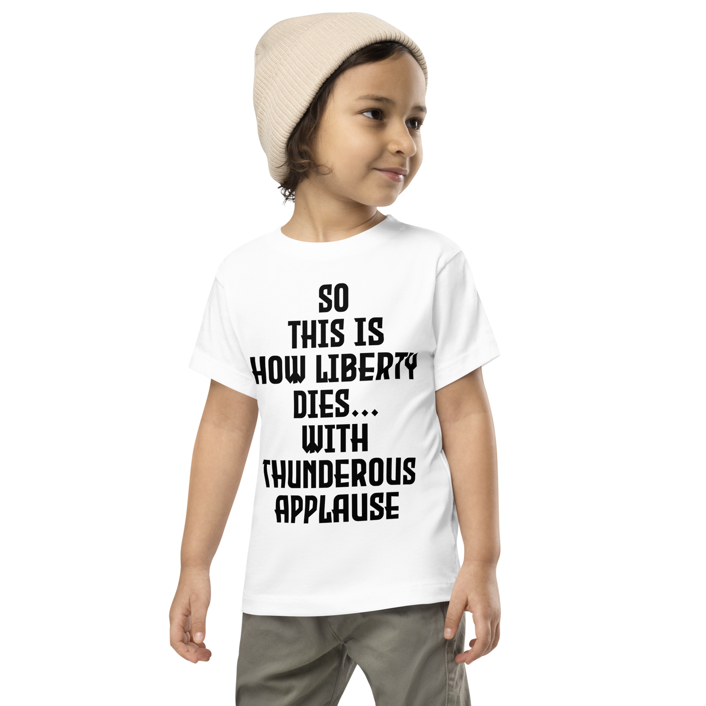 "So this is how liberty dies… with thunderous applause" printed on a white toddler short sleeve tee worn by a male wearing a cap