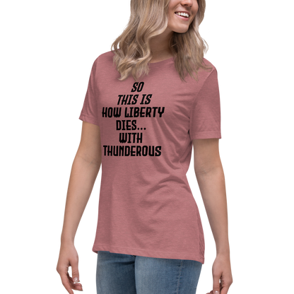"So this is how liberty dies… with thunderous applause" printed on a heather mauve women's relaxed t-shirt worn by a female