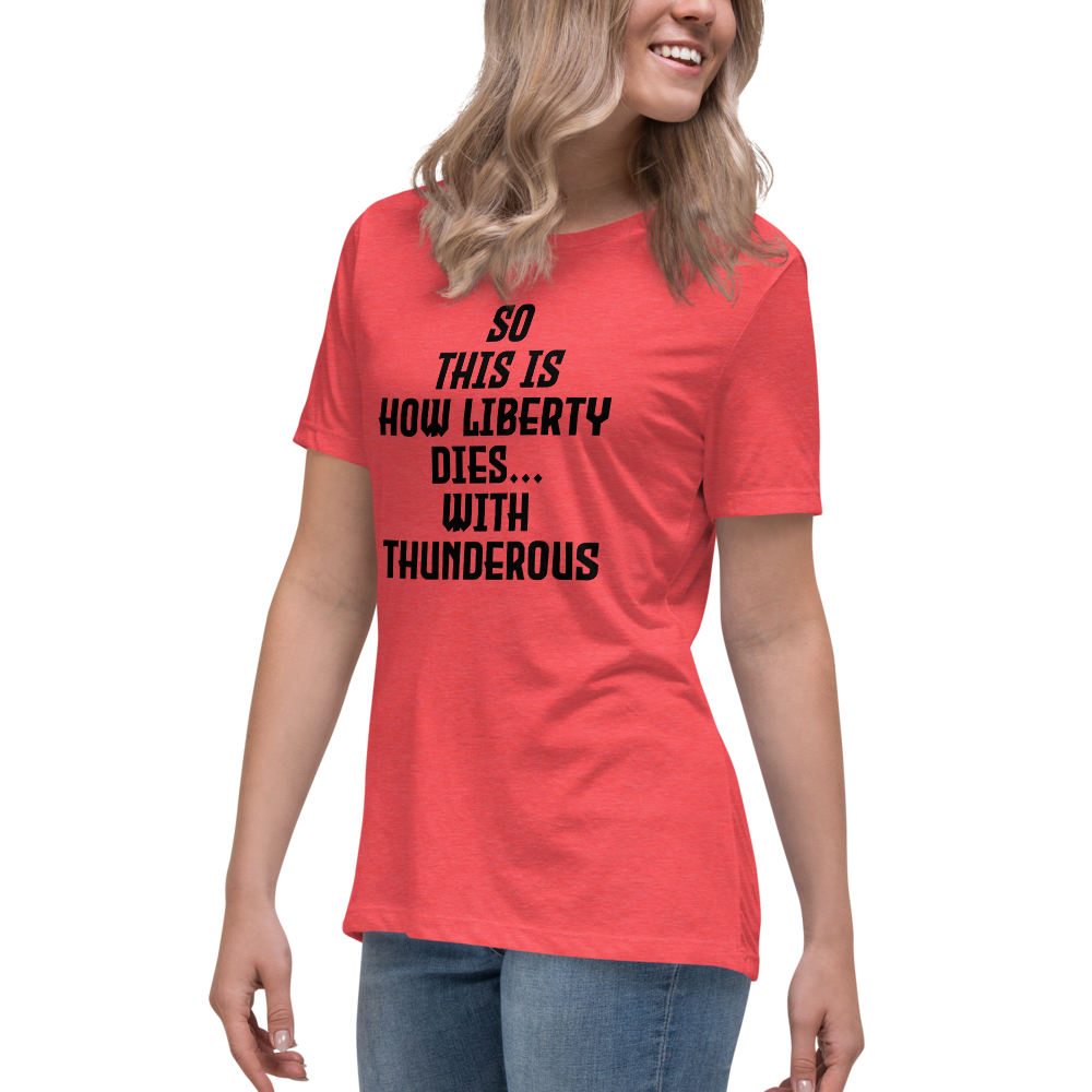"So this is how liberty dies… with thunderous applause" printed on a heather red women's relaxed t-shirt worn by a female