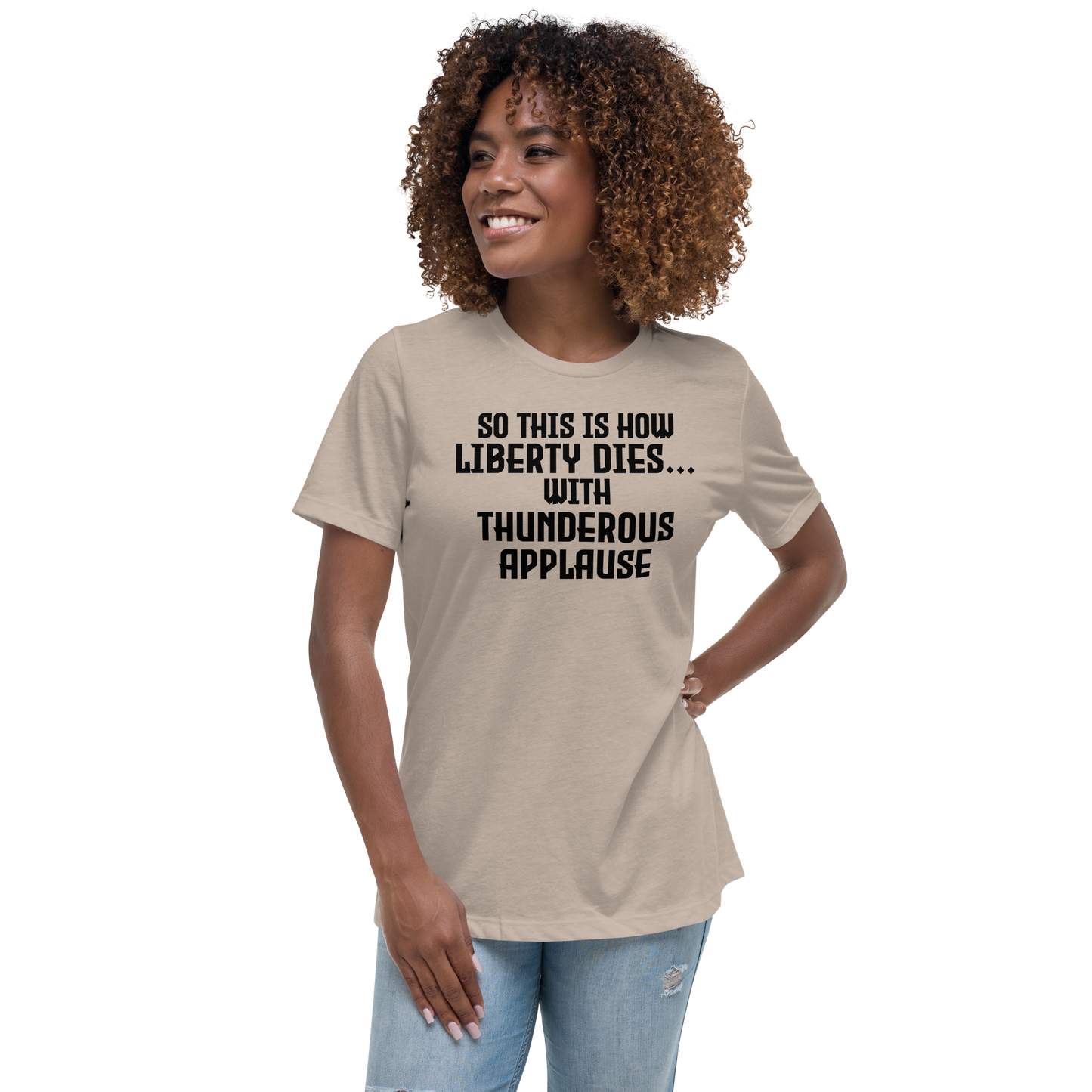 "So this is how liberty dies… with thunderous applause" printed on a heather stone women's relaxed t-shirt worn by a female