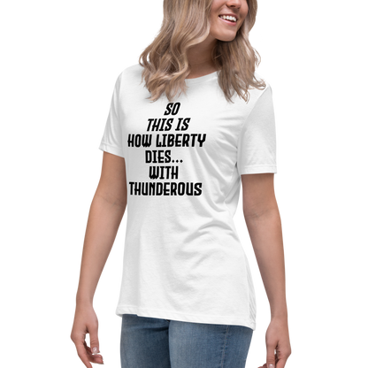 "So this is how liberty dies… with thunderous applause" printed on a white women's relaxed t-shirt worn by a female