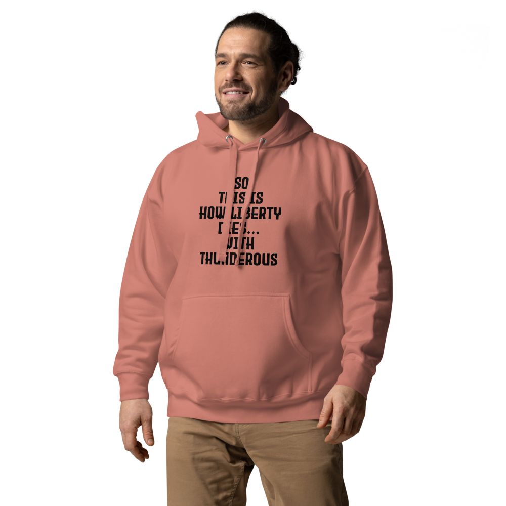 "So this is how liberty dies… with thunderous applause" printed on a dusty rose unisex hoodie worn by a male