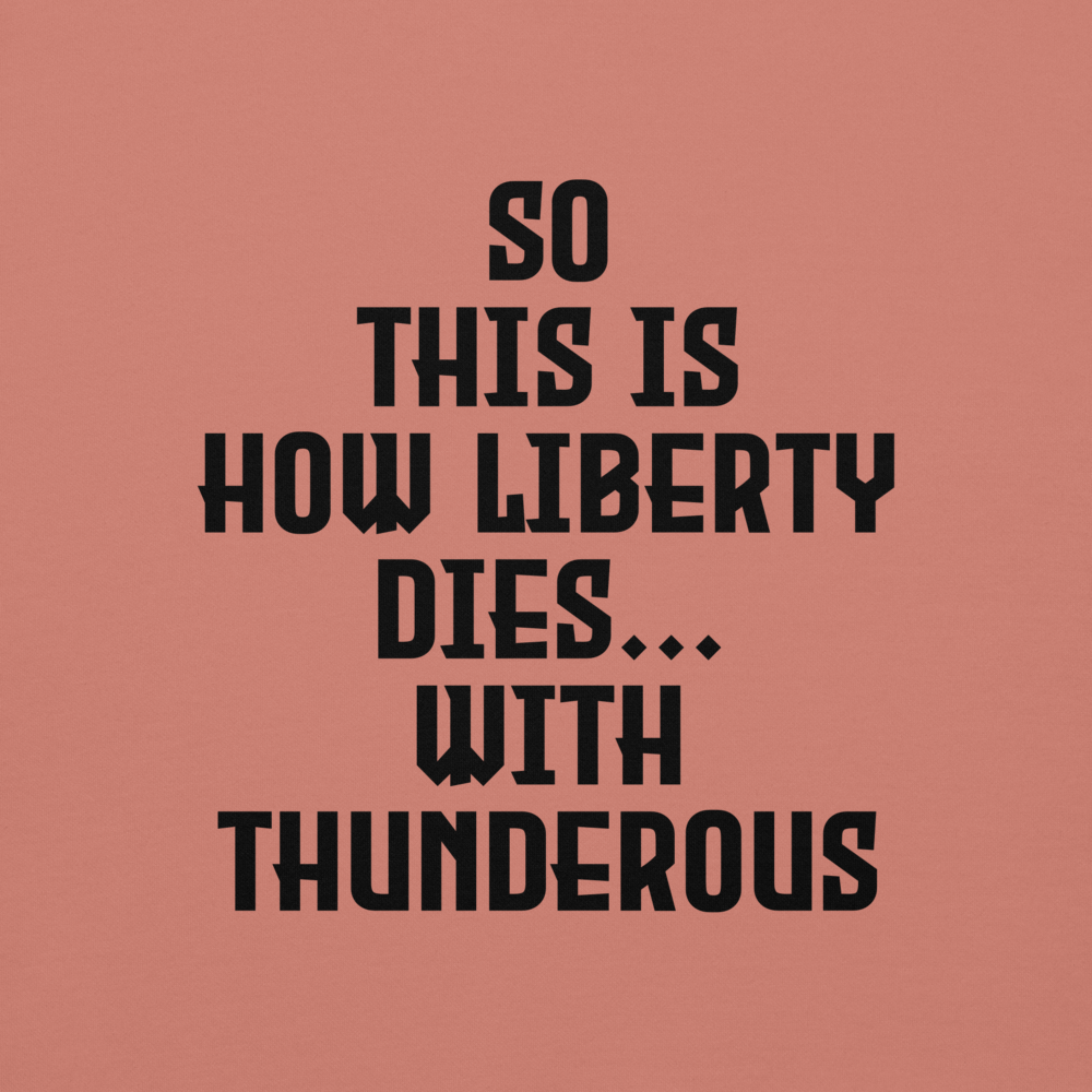 "So this is how liberty dies… with thunderous applause" printed on a dusty rose background