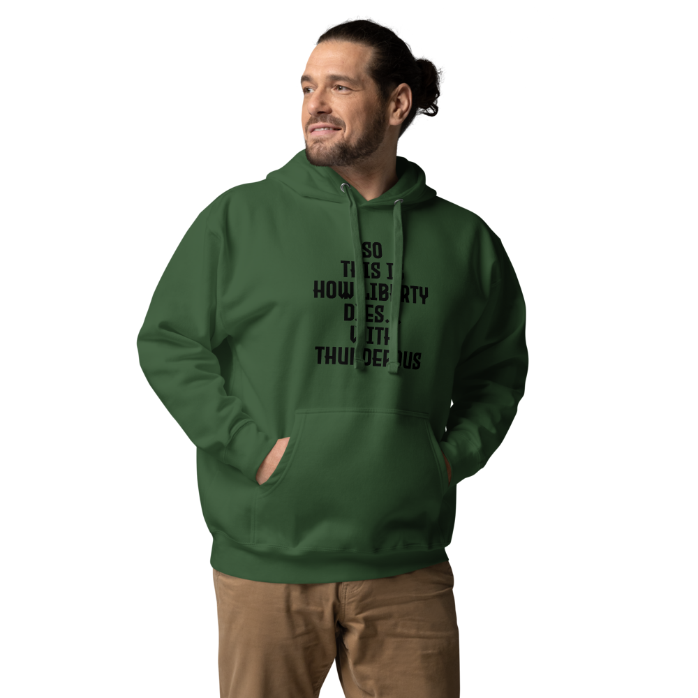 "So this is how liberty dies… with thunderous applause" printed on a forest green unisex hoodie worn by a male