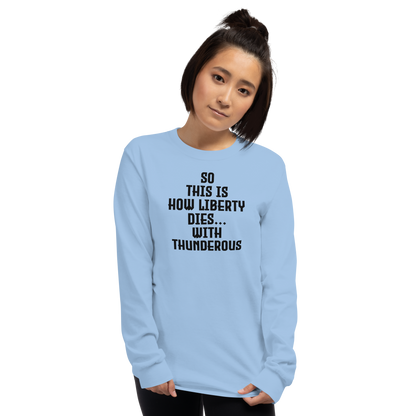 "So this is how liberty dies… with thunderous applause" printed on a light blue men's long sleeve shirt worn by a female