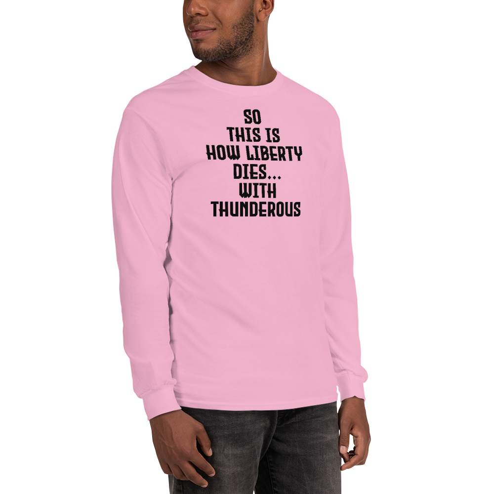 "So this is how liberty dies… with thunderous applause" printed on a light pink men's long sleeve shirt worn by a male