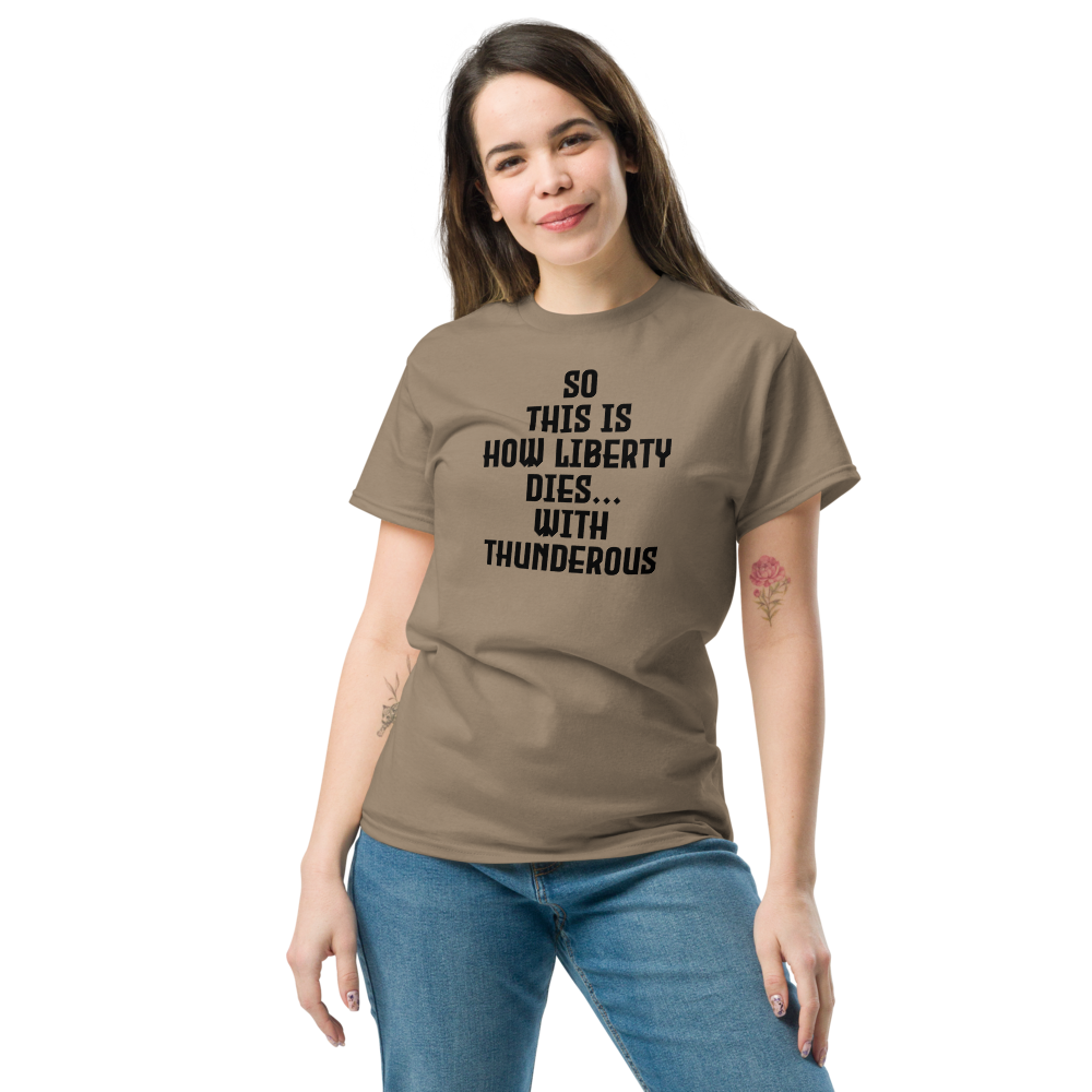 "So this is how liberty dies… with thunderous applause" printed on a brown savana unisex classic tee worn by a female