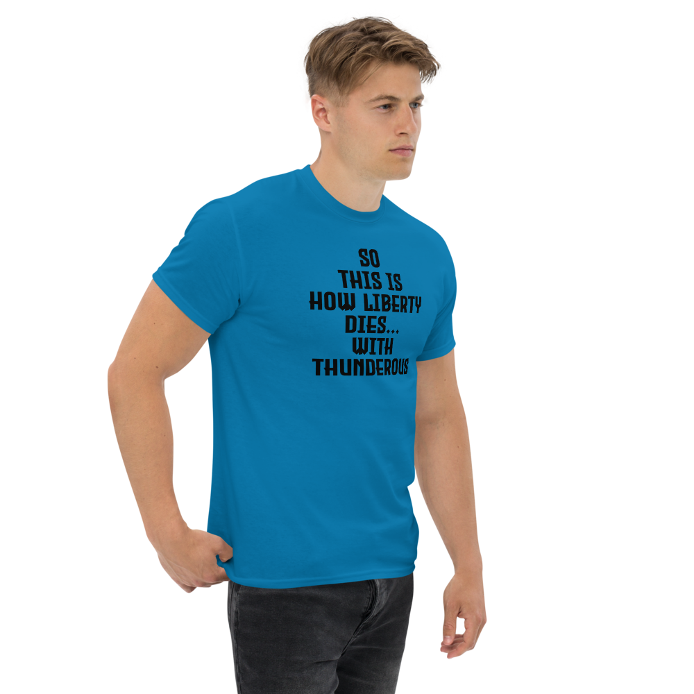 "So this is how liberty dies… with thunderous applause" printed on a sapphire unisex classic tee worn by a male