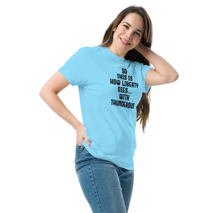 "So this is how liberty dies… with thunderous applause" printed on a sky unisex classic tee worn by a female